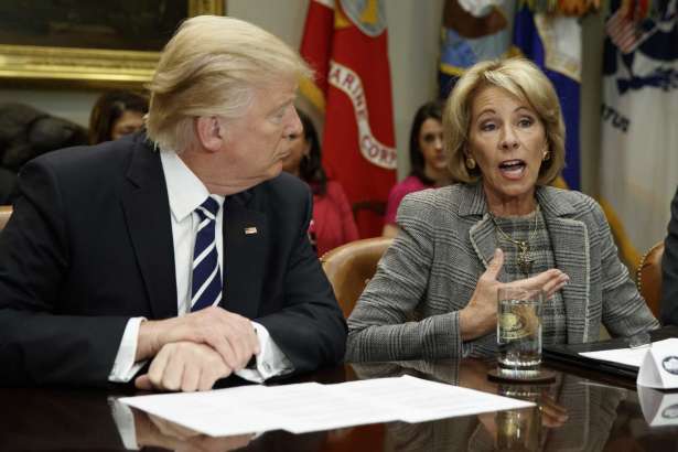 President Donald Trump listens as Education Secretary Betsy DeVos speaks during a meeting with parents and teachers, Tuesday, Feb. 14, 2017, in the Roosevelt Room of the White House in Washington.