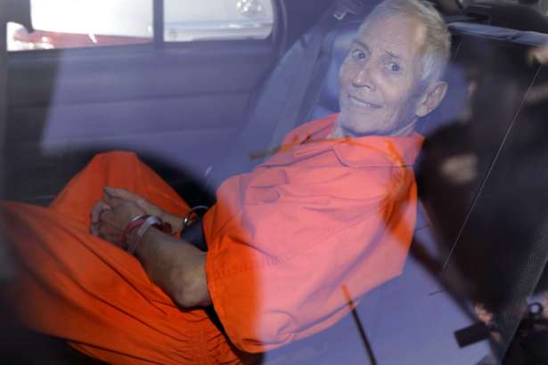 FILE - In March 17, 2015, file photo, New York real estate heir Robert Durst smiles as he is transported from Orleans Parish Criminal District Court to the Orleans Parish Prison after his arraignment on murder charges in New Orleans. Durst's close friend Nathan Chavin said Friday, Feb. 17, 2017, that it took seven months for him to come clean and tell prosecutors what the real estate heir said about killing their close friend. Chavin said he struggled during that time to balance his loyalties to two best friends before deciding to tell "the whole truth" about what he knew about Susan Berman's death.