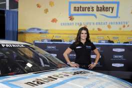 FILE - In this Aug. 18, 2015, file photo, Danica Patrick poses by her new race car during a news conference to announce a new sponsorship for her NASCAR auto racing team at Stewart-Haas Racing's headquarters in Kannapolis, N.C. One of Danica Patrick's sponsors has stepped up to fill a sudden funding void created when Stewart-Haas Racing sued her primary backer for $31 million in a breach of contract suit. Aspen Dental said Tuesday, Feb. 14, 2017,  it will be the lead sponsor for Patrick and debut on her car in the Feb. 26 season-opening Daytona 500. Patrick and SHR were left with 20-some races to fill less than two weeks before teams report to Daytona International Speedway because of a nasty split between the team and primary sponsor Nature's Bakery.