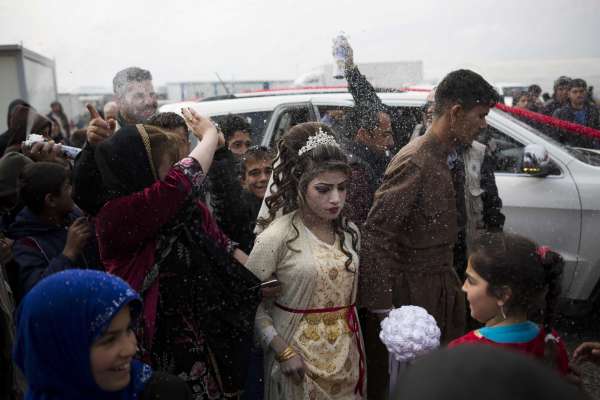 Hussein Zeino Danoon and Shahad Ahmed Abed arrive at the Khazer camp for people displaced from Mosul for their wedding on Thursday, Feb. 16, 2017. It's the second marriage to take place in the IDP camps east of the city where tens of thousands are living, having fled the fighting in Mosul.