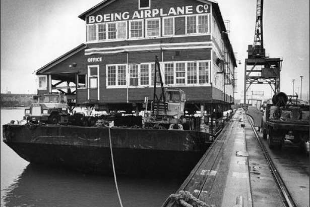 Boeing's "Red Barn," vintage 1910, was loaded aboard a Foss barge on Dec. 16, 1975 for a trip down the Duwamish from Terminal 115 to a new museum-site home on the southwest corner of Boeing Field. The original Boeing Plant was designated a National Historical Place. (P-I photo by Cary Tolman)
