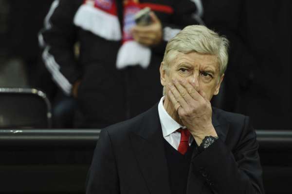 Arsenal's manager Arsene Wenger covers his face prior to the first leg of the Champions League round of 16 soccer match between Bayern Munich and FC Arsenal in the Allianz Arena in Munich, Germany, Wednesday, Feb. 15 , 2017. (Sven Hoppe/dpa via AP)