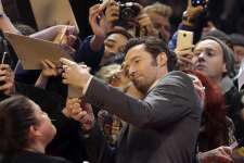 Actor Hugh Jackman poses with fans on the red carpet for the film 'Logan' at the 2017 Berlinale Film Festival in Berlin, Germany, Friday, Feb. 17, 2017.