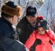 Asylum seeker children are helped into Canada by Royal Canadian Mounted Police officers along the US-Canada border near ...