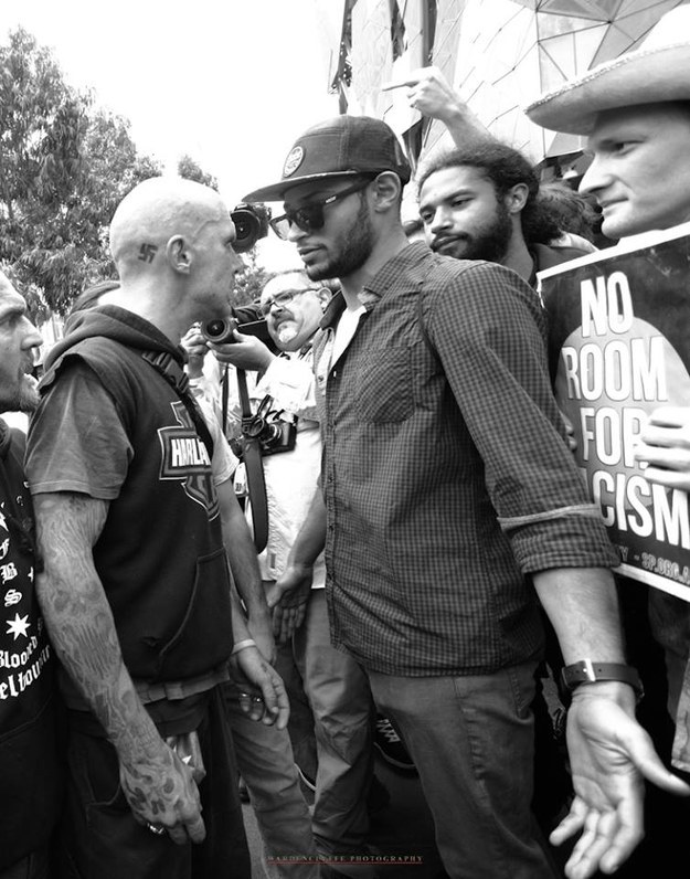 A counter-protestor calmly stands in the way of a man with a swastika tattoo at the Melbourne Reclaim rally - photo by Kenji Wardenclyffe