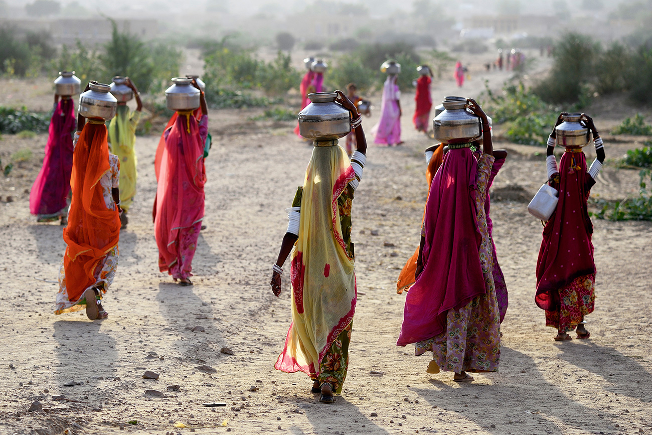 Women carring water from a well