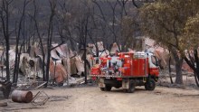 A fire engine in front of a burnt-out property near Carwoola.