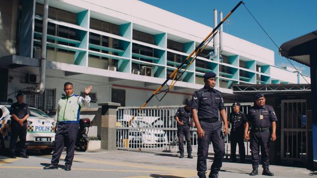 Police officers guard the entrance of the forensic department of Kuala Lumpur General Hospital on Wednesday.