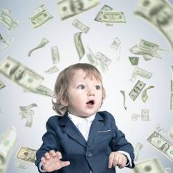 A child surrounded by flying dollar bills.