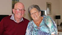 Older couple sitting together at their dining table.