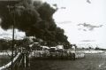 Darwin, 19 February 1942. People at Government House look at the smoke billowing from ships ablaze in the harbour after ...