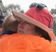 Vanessa Lindley is comforted by friends after her property is destroyed after a fast moving bush fire at Widgiewa Rd on ...