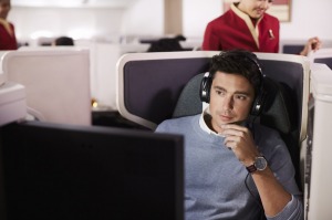 A business class passenger enjoys Cathay Pacific's inflight entertainment. 