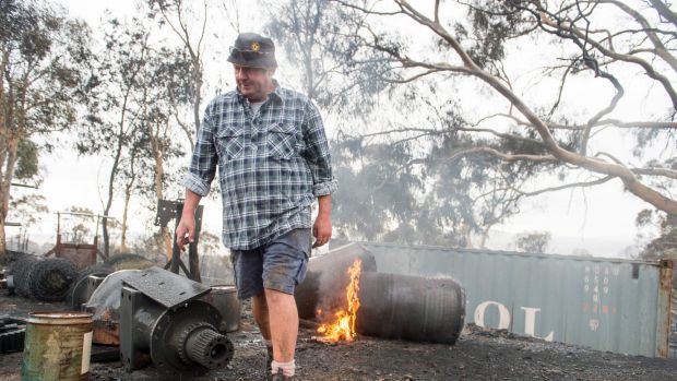 Kevin Lindley walks among the ruins of his property.