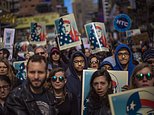 People carry posters during a rally in support of Muslim Americans and protest of President Donald Trump's immigration policies in Times Square, New York, Sunday, Feb. 19, 2017. (AP Photo/Andres Kudacki)