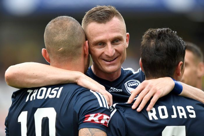 Besart Berisha embraces James Troisi and Marco Rojas