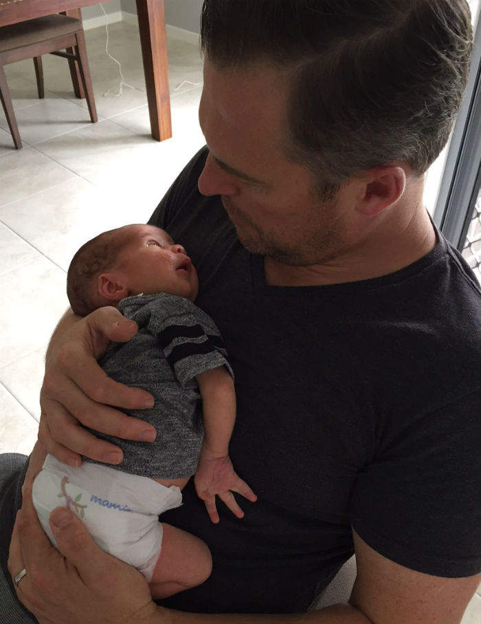 Dad holding newborn on chest