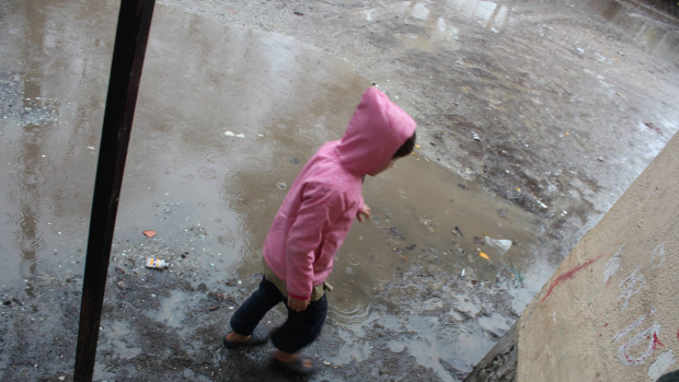 A child plays in the sodden Serres refugee camp in northern Greece. Photo: Hashim Kheri Kutu