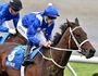 Hugh Bowman rides Winx (right) past the post in the Cox Plate at Moonee Valley Racecourse last October.