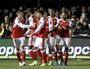 Arsenal's players celebrate Theo Walcott's, right, goal during the English FA Cup fifth round soccer match against Sutton United at Gander Green Lane stadium in London