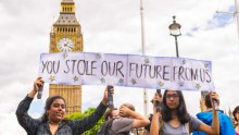 Two students hold protest sign with Big Ben in background