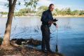 Ross Thompson, chair of water science at the ANU testing water quality at Lake Burley Griffin.