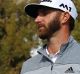 Dustin Johnson and spectators react as Johnson nearly holes out after chipping onto the eighth green during the final ...