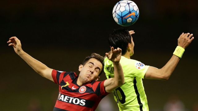 Walloping: Steve Lustica of the Wanderers contests the ball against Ryota Moriwaki of Urawa Red Diamonds at Campbelltown ...