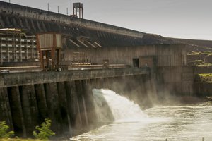 Itaipu Hydroelectric Dam is the largest operational hydroelectric energy producer in the world, with an installed generation capacity of 14GW. The plant is operated by Itaipu Binacional and located on the border between Brazil and Paraguay. Energy generated by Itaipu helps meet demands from the two countries. About 90% of the energy generated by the plant is used by Brazil.The dam and the plant are on the Paraná River. Construction of the dam began in February 1971 and cost $19.6bn. The first unit began generating power in May 1984. The second generating unit started operating the same year. As of 2009 Itaipu has 20 generating units, each with a capacity of 700MW.The dam's reservoir, which covers an area of 1,350km?, is the seventh-largest reservoir in Brazil, with a best coefficient of water utilisation of 10.4MW/km?. Itaipu generated 94.68 billion kWh of energy in 2008, sufficient to meet worldwide power consumption for two days.