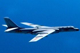 A Chinese bomber patrols South China Sea reefs and islands. US officials believe that buildings installed on some of the ...