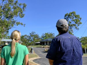 CONCERNED: Deebing Heights residents Darryl Beyer and Jenny Harrison look over the approved Optus mobile phone tower site.