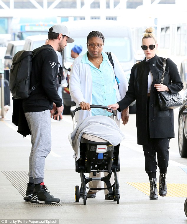 Family flight: Maksim Chmerkovskiy and Peta Murgatroyd arrived back at LAX Aiport with one-month-old son Shai on Friday