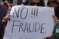 A supporter of Guillermo Lasso holds a sign reading "No to Fraud!" during Monday's protest in Quito.