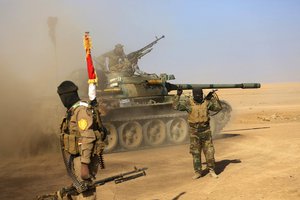 Fighters of Popular Mobilization at the fighting lines against Islamic State Group militants outside Mosul, Iraq, Saturday, Nov. 26, 2016.