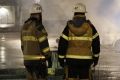 Firefighters keep watch over the riot. in the Stockholm suburb of Rinkeby.