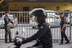 Malaysian police officers guard the gate of the forensic department at Kuala Lumpur Hospital in Kuala Lumpur, Malaysia, Monday, Feb. 20, 2017.