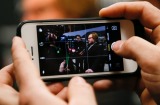 Tap the main focal point to readjust the focus. Actor Jack Black is photographed with an iPhone while he is interviewed ...