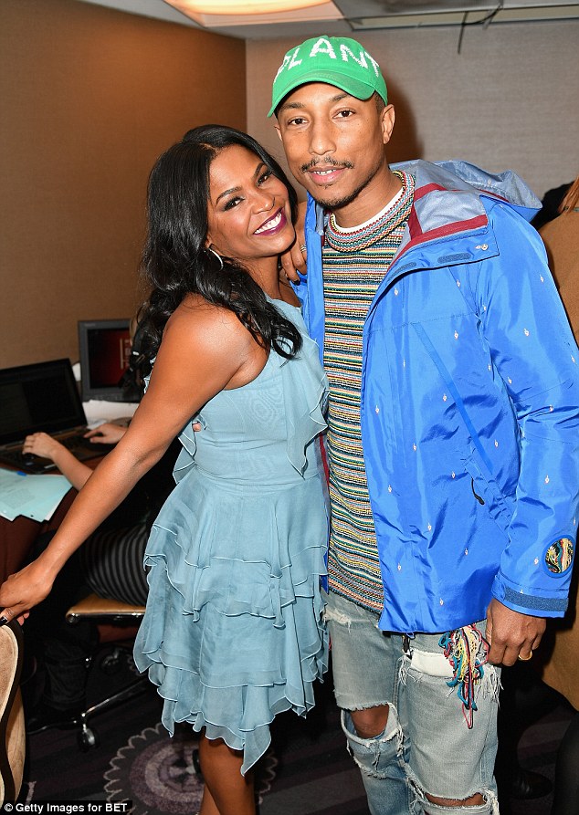 Legends: Posing alongside Friday actress Nia Long, he added a bright green cap and blue anorak, putting on a colourful display