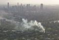 Smoke spreads across the city's south-west from the blaze in Taringa.