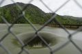 Water flows into the iconic Glory Hole spillway at Monticello Dam.