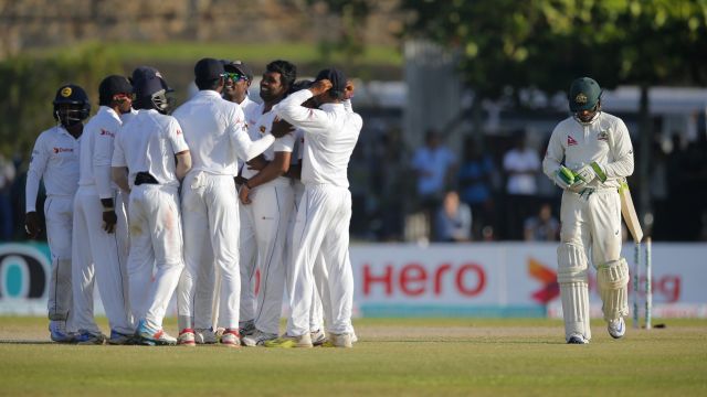 Down and out: Usman Khawaja trudges off as the Sri Lankans celebrate on day two of the second Test.