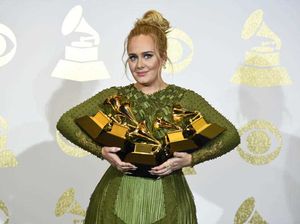 Adele poses in the press room with the awards for album of the year for "25", song of the year for "Hello", record of the year for "Hello", best pop solo performance for "Hello", and best pop vocal album for "25" at the 59th annual Grammy Awards. (Photo by Chris Pizzello/Invision/AP)