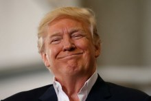 US President Donald Trump smiles a as he holds a "Make America Great Again" rally