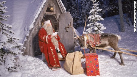 A pictured dated 02 November 2000 shows Santa Claus reading letters sent by children from all over the world, in front of his home in the Arctic Circle, in Finnish Lapland. Santa Claus is expecting to welcome some 120,000 visitors from around the world in Finnish Lapland above the Arctic Circle this holiday season, the local tourism office said on 27 November 2007. AFP PHOTO/LEHTIKUVA/MARTTI KAINULAINEN *** FINLAND OUT *** (Photo credit should read MARTTI KAINULAINEN/AFP/Getty Images)