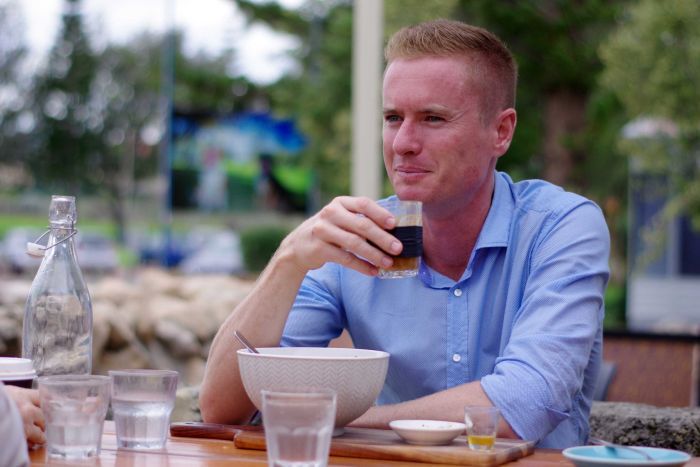 Albert Jacob sitting at an outdoor table having coffee.