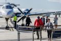 Passengers disembark a chartered flight at Essendon Fields Airport, Melbourne on Thursday.