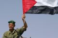 A Palestinian security force personnel holding a Palestinian flag celebrates while deployment near the Jewish settlement ...