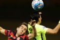 Walloping: Steve Lustica of the Wanderers contests the ball against Ryota Moriwaki of Urawa Red Diamonds at Campbelltown ...