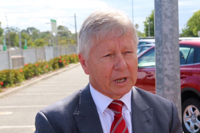 Headshot of WA Transport Minister Bill Marmion standing outside a train station.