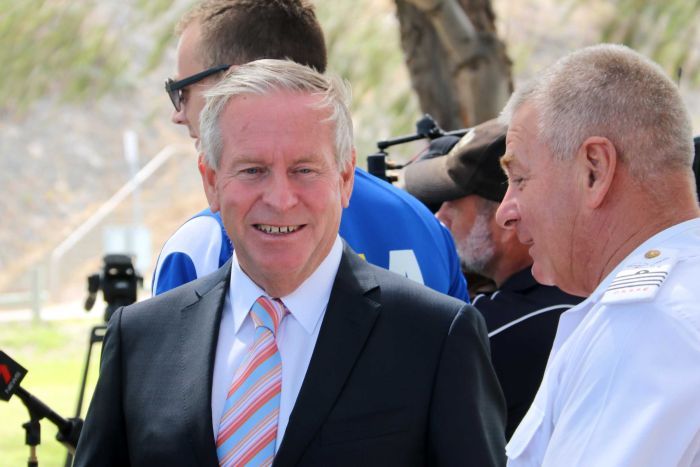 Headshot of WA Premier Colin Barnett with camera crews in background.